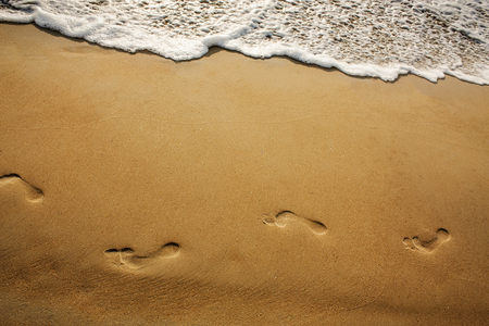 footprints on the sand at the beachの写真素材