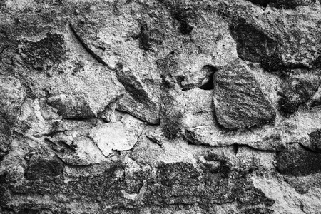 weathered cobblestone wall background black and whiteの写真素材