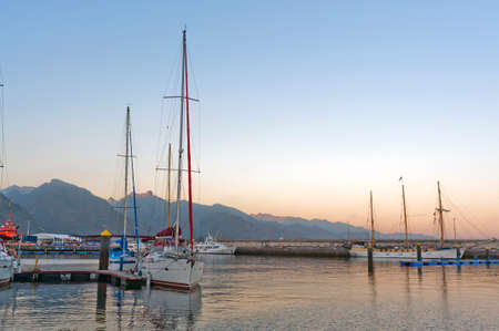 Marina in the evening on the island of Gomera in the background of mountainsの写真素材