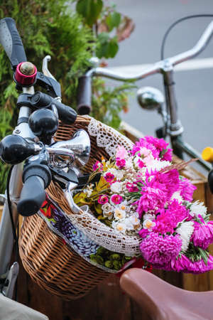 Photography of Flowers in a basket on the handlebars in a retro styleの写真素材