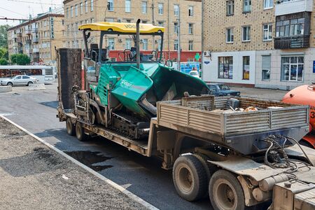 Krasnoyarsk, Russia - July 26, 2018: Transportation of the asphalt spreader to the venue of works.