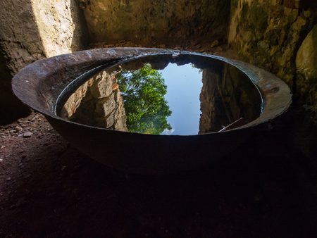 Rusted Basin Full of Water, Reflecting Forest and Sky, Ruinsの写真素材