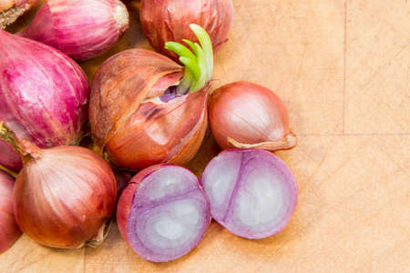Shallot onions on a wooden boardの写真素材