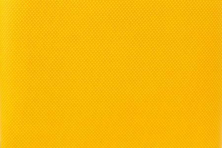 Macro of a yellow colour graphic grid  against background texture