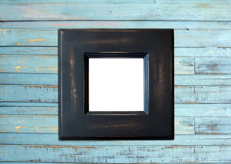 Black Vintage picture frame, wood plated, blue wood background, clipping path includedの写真素材