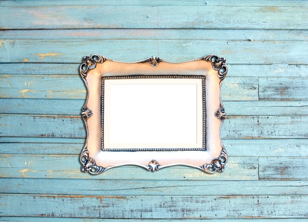 Gold Vintage picture frame, wood plated, blue wood background, clipping path includedの写真素材