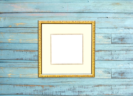 Gold Vintage picture frame, wood plated, blue wood background, clipping path includedの写真素材