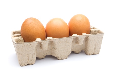Three eggs in the package isolated on white background