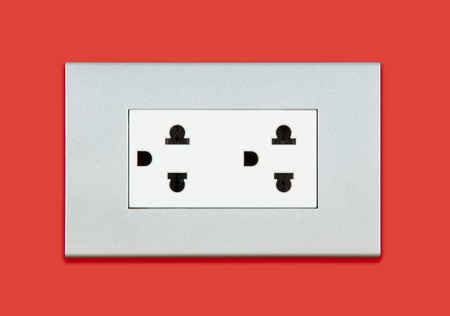 Plug socket on red background