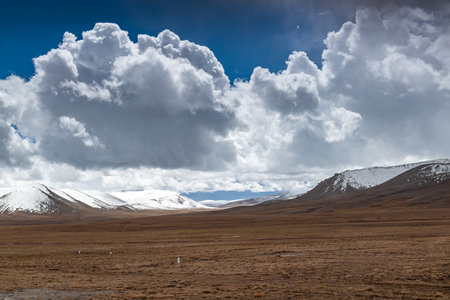 Snowy mountains and land in cloudy weather.の写真素材