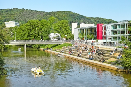 Marburg, Germany - June 11, 2013: Marburg University Campus, Lahn River, and students relaxing in front of canteen and cafeteria.のeditorial素材