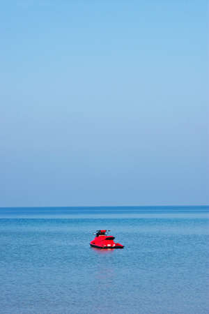 Red jet ski on blue seaの写真素材