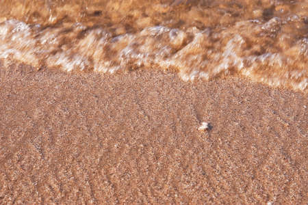 Wave moving on sand beachの写真素材