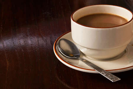 Cup of coffee on wooden floorの写真素材