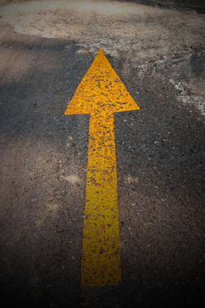 Yellow narrow sign on roadの写真素材