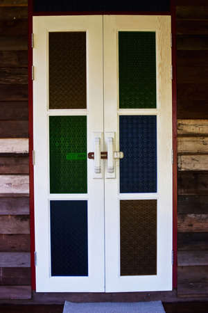 White wooden door and color glassesの写真素材