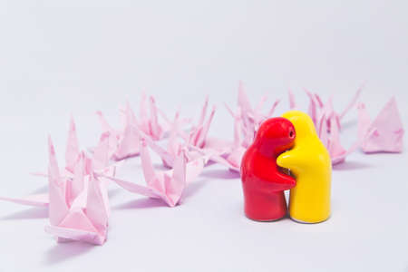 Lover dolls and paper bird isolate on whiteの写真素材