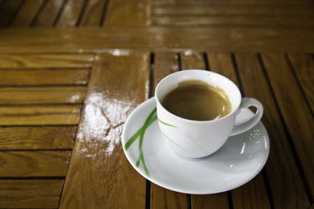 A cup of coffee on wooden tableの写真素材