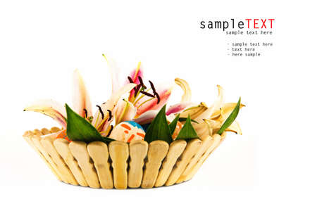 Basket full of Easter eggs and flower isolated on whiteの写真素材