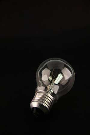 Light bulb isolated on black backgroundの写真素材