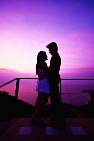 A couple getting ready to kiss each other by sunset backgroundの写真素材