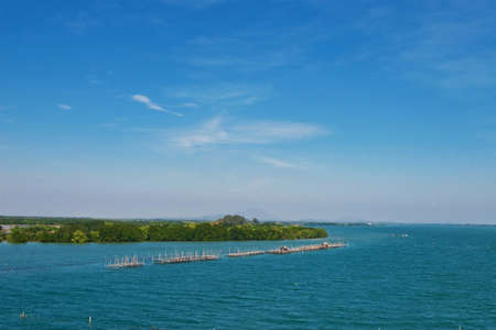 Wooden pier in the sea and blue skyの写真素材