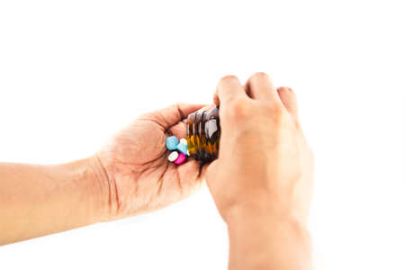 Woman's hands holding pills, isolate on white backgroundの写真素材