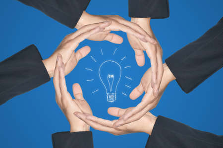 Hands made circle saving energy from light bulb iconの写真素材