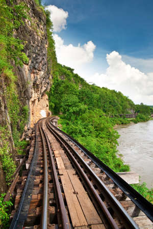 Dead railway beside cliff along Kwai river in Thailandの写真素材