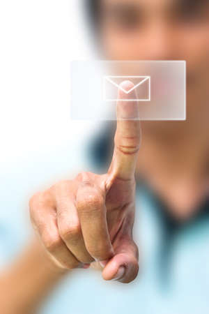 Man pushing email icon on touch screen padの写真素材