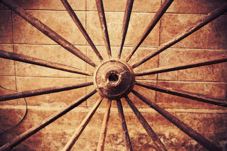 Grunge wooden wheel on concrete wallの写真素材