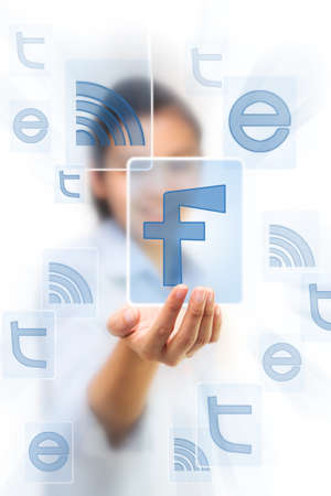 Hand holding icons on touch screen padのeditorial素材