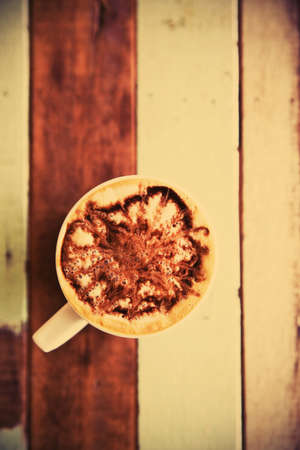 Cup of coffee on wooden table vintageの写真素材