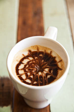 A cup of coffee on wooden backgroundの写真素材