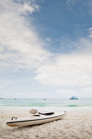 Kayak boat on white sand beachの写真素材