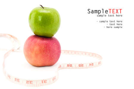 Apple fruit with measuring tape in shape of heart, on white backgroundの写真素材