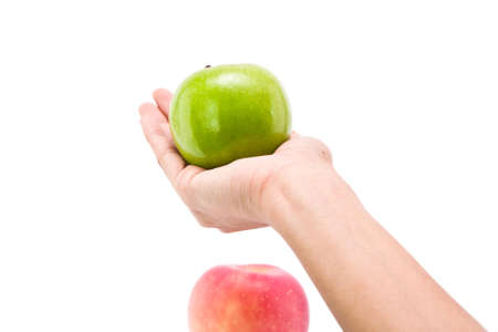Hand holding green apple, isolate on white backgroundの写真素材