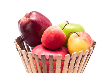 Apple fruits in basket, isolated on white backgroundの写真素材