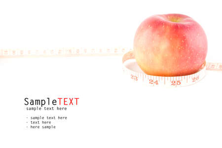 Measuring tape around red apple, isolate on white backgroundの写真素材