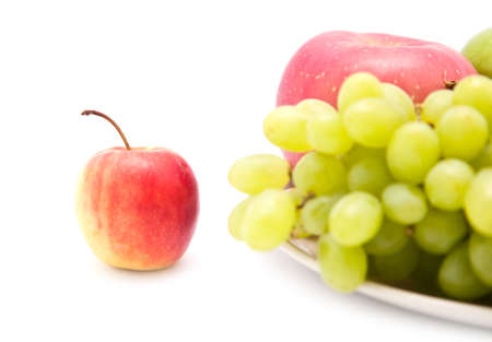 Apple beside grape fruit, isolated on white backgroundの写真素材
