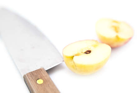 Half of apple fruit with knife, isolated on white backgroundの写真素材