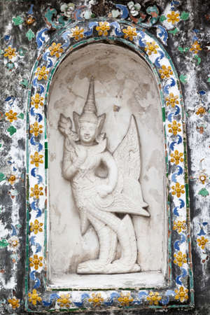 Grunge statue on temple wall, Thailandの写真素材