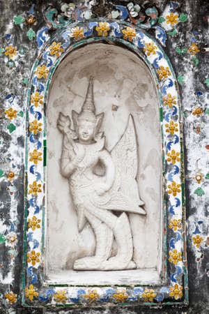 Grunge statue on temple wallの写真素材