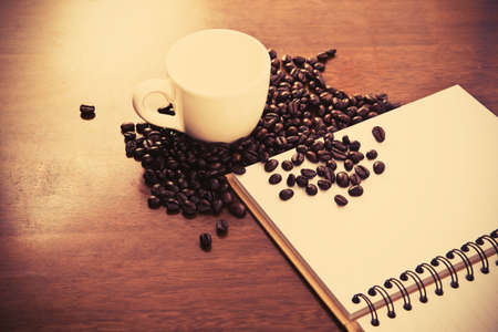 Coffee cup and beans with bookの写真素材