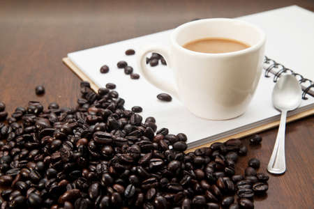 Cup of coffee and book with beansの写真素材