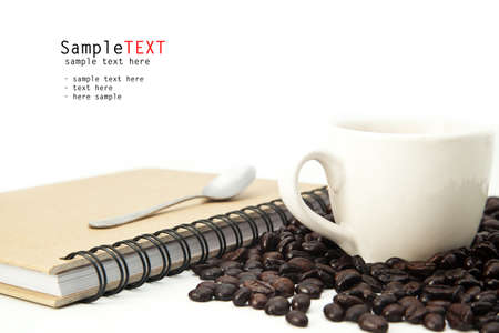 Closeup cup of coffee and book on white backgroundの写真素材