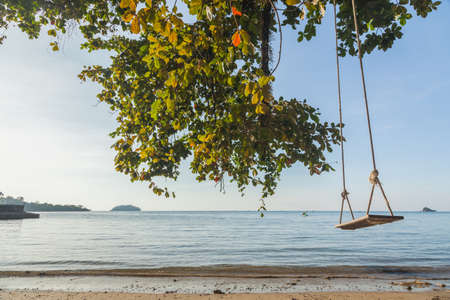 Tropical sea beach with swing tied, Thailandの写真素材