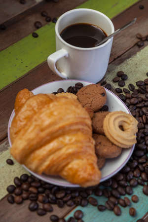 Cup of coffee with cookies foregroundの写真素材