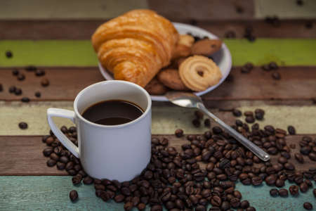 Cup of coffee with beans and cookiesの写真素材