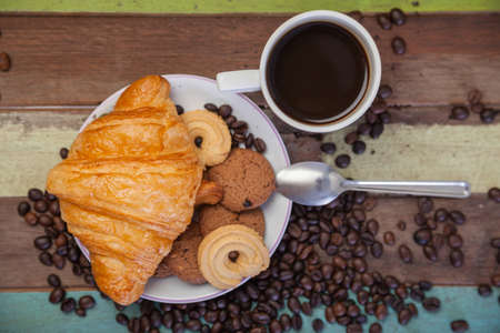 Cup of coffee with cookies and beansの写真素材
